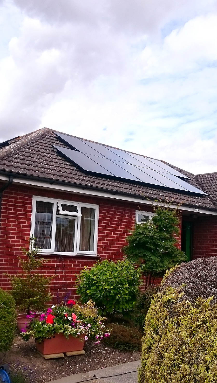 Solar panels on the roof of a large bungalow near Cambridge