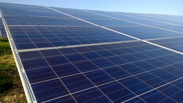 Shining solar panels near Cambridge working hard at full capacity