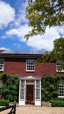 Large detached house in Cambridge outskirts with massive solar panels producing electricity