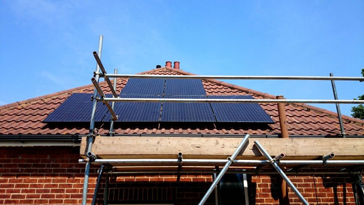 Work in progress solar panels installation on a pyramid style roof near Cambridge
