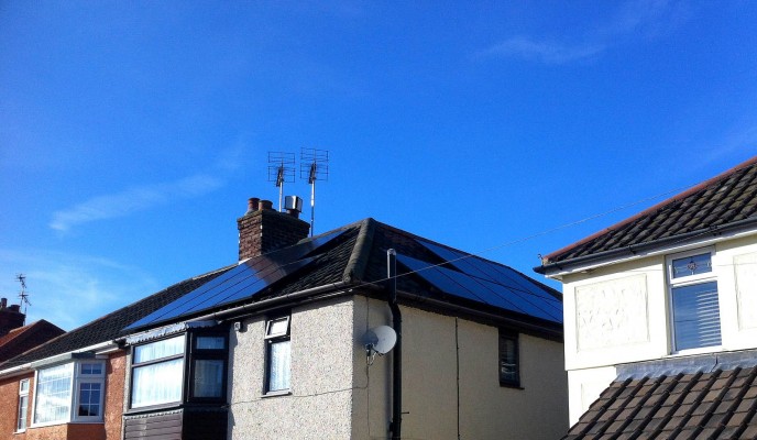 Cambridge village house with two sets of solar panels producing green energy